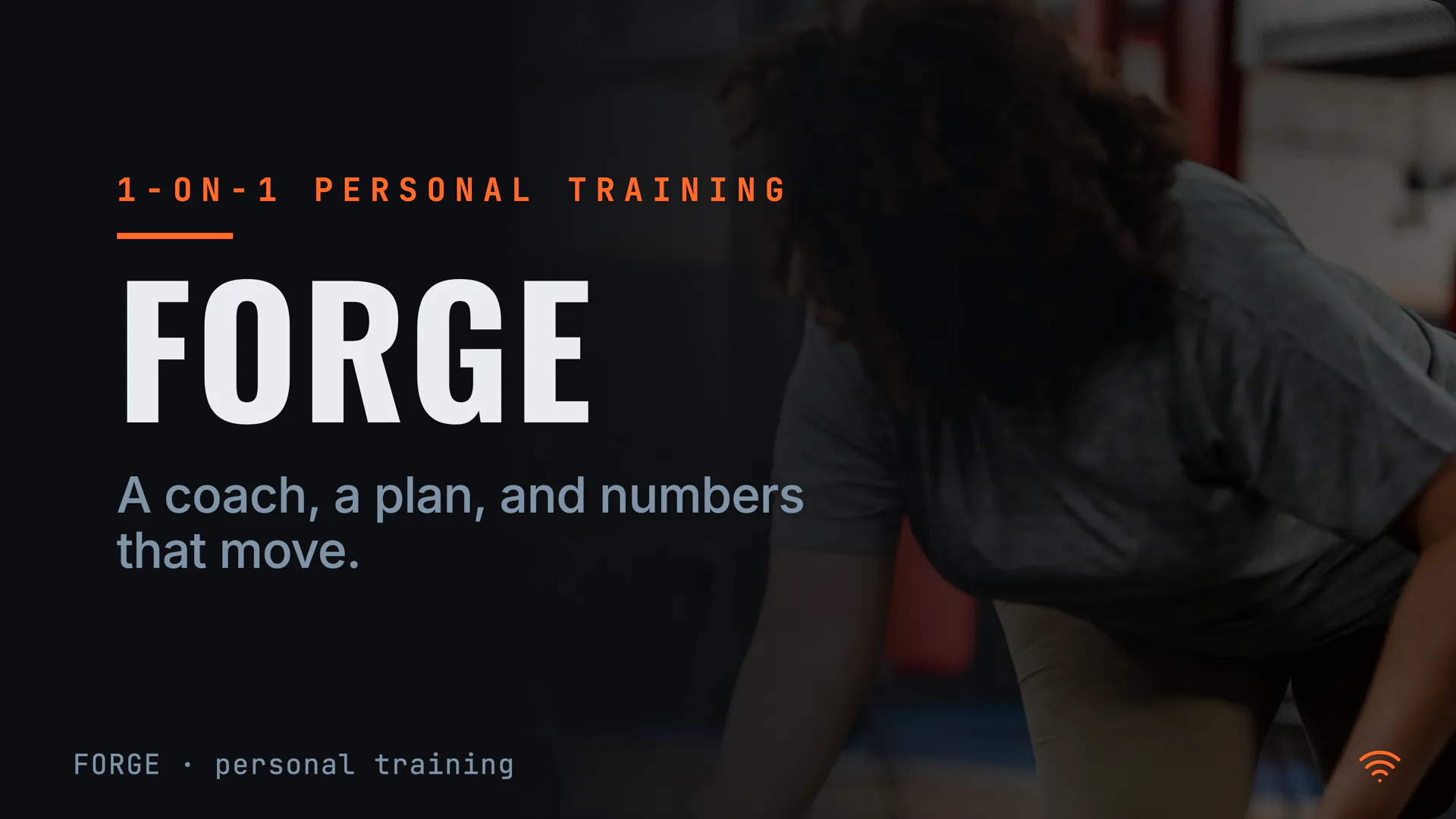 A gym board on a TV, showing the studio name and its personal-training line